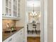 Butler's pantry featuring granite counters and custom cabinets that lead into the dining room at 1734 Doonbeg Ct, Kennesaw, GA 30152