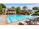 Resort-style community pool with waterslide, tower, lounge chairs and beautiful clubhouse at 1734 Doonbeg Ct, Kennesaw, GA 30152