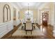 Open-concept dining room featuring elegant furnishings, hardwood floors, and natural light at 1734 Doonbeg Ct, Kennesaw, GA 30152