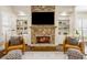 Cozy stone fireplace with custom built-ins, providing a warm and inviting ambiance at 1734 Doonbeg Ct, Kennesaw, GA 30152
