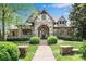 Inviting front exterior featuring stone accents, arched entryway, and manicured landscaping at 1734 Doonbeg Ct, Kennesaw, GA 30152