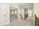 Hallway with carpeted floor, railing staircase and doorways leading to the bedrooms at 1734 Doonbeg Ct, Kennesaw, GA 30152