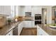 This is a stunning kitchen with granite counters, stainless steel appliances, and hardwood floors at 1734 Doonbeg Ct, Kennesaw, GA 30152