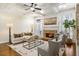 Bright living room featuring hardwood floors, fireplace, and coffered ceilings at 1734 Doonbeg Ct, Kennesaw, GA 30152