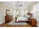 Primary bedroom with tray ceilings, hardwood floors, an area rug, and beautiful furnishings at 1734 Doonbeg Ct, Kennesaw, GA 30152