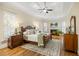 Spacious primary bedroom suite with a fireplace, hardwood floors and lots of natural light at 1734 Doonbeg Ct, Kennesaw, GA 30152