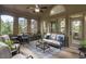Charming screened patio with comfortable furniture and a ceiling fan, perfect for outdoor relaxation at 1734 Doonbeg Ct, Kennesaw, GA 30152