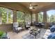 Inviting screened patio with cozy seating, a ceiling fan, and views of lush greenery at 1734 Doonbeg Ct, Kennesaw, GA 30152