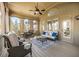 Relaxing screened patio with comfortable seating and a ceiling fan for outdoor enjoyment at 1734 Doonbeg Ct, Kennesaw, GA 30152