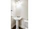 This is a powder room with a pedestal sink, dark wood floors, and a tiled accent wall at 1734 Doonbeg Ct, Kennesaw, GA 30152