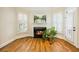 Cozy sitting area with a fireplace, hardwood floors and a large window with plantation shutters at 1734 Doonbeg Ct, Kennesaw, GA 30152