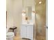 Bathroom featuring a vanity with white cabinets, a mirror with sconces, and glass shower at 2828 Peachtree Nw Rd # 903, Atlanta, GA 30305