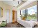 Bedroom with ensuite bathroom featuring a large window with city views and minimalist decor at 2828 Peachtree Nw Rd # 903, Atlanta, GA 30305