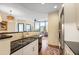 Kitchen featuring stainless steel appliances, black countertops and hardwood floors at 2828 Peachtree Nw Rd # 903, Atlanta, GA 30305