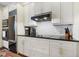 Well-lit kitchen featuring white cabinets, stainless steel appliances, and ample counter space at 2828 Peachtree Nw Rd # 903, Atlanta, GA 30305