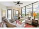 Bright living room features large windows, comfortable seating, ceiling fan, and stylish decor at 2828 Peachtree Nw Rd # 903, Atlanta, GA 30305