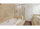 Bathroom showcasing a soaking tub, a glass shower, and vanity with granite counters at 2828 Peachtree Nw Rd # 903, Atlanta, GA 30305