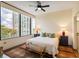 Bedroom featuring a large window with city views, neutral decor, and ensuite bathroom at 2828 Peachtree Nw Rd # 903, Atlanta, GA 30305