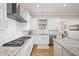 Updated kitchen featuring herringbone tile backsplash, granite countertops and stainless steel appliances, with breakfast nook nearby at 3576 Sexton Woods Dr, Chamblee, GA 30341