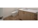Modern half-bathroom with wood cabinets, a white countertop, and a toilet at 2425 Peachtree Ne Rd # 1604, Atlanta, GA 30305