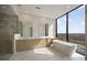 Modern bathroom featuring marble floors, double vanity, glass shower, and soaking tub with a scenic window view at 2425 Peachtree Ne Rd # 1604, Atlanta, GA 30305