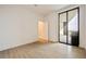 This modern bedroom has hardwood floors and large sliding glass doors to the balcony at 2425 Peachtree Ne Rd # 1604, Atlanta, GA 30305