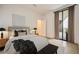 A beautifully styled modern bedroom provides balcony access through large sliding glass doors at 2425 Peachtree Ne Rd # 1604, Atlanta, GA 30305