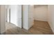 Hallway with light hardwood floors and white doors to access different rooms at 2425 Peachtree Ne Rd # 1604, Atlanta, GA 30305