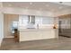 Gourmet kitchen with custom cabinets, quartz countertops, stainless steel appliances, and large island at 2425 Peachtree Ne Rd # 1604, Atlanta, GA 30305
