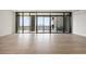 Hardwood floor living room highlighting expansive city views and an outdoor grill on the balcony at 2425 Peachtree Ne Rd # 1604, Atlanta, GA 30305