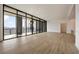 Bright, open living room featuring hardwood floors, floor-to-ceiling windows, and a balcony with scenic views at 2425 Peachtree Ne Rd # 1604, Atlanta, GA 30305