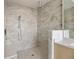 Luxurious glass shower with marble tile, rainfall showerhead, and built-in bench seating at 2425 Peachtree Ne Rd # 1604, Atlanta, GA 30305