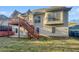 A backyard with a deck featuring wooden stairs that lead to a covered patio at 4540 Flat Willow Pl, Douglasville, GA 30135