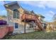 Two-story house exterior with a backyard featuring a wooden deck and staircase at 4540 Flat Willow Pl, Douglasville, GA 30135