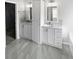 Bathroom featuring dual vanities with white cabinets, white countertops, and tile flooring at 4540 Flat Willow Pl, Douglasville, GA 30135