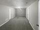 Carpeted bedroom featuring neutral walls, a ceiling light, and two doors at 4540 Flat Willow Pl, Douglasville, GA 30135