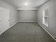 Bedroom with neutral colored walls, neutral carpet, and a large window at 4540 Flat Willow Pl, Douglasville, GA 30135