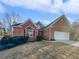 Charming brick home featuring a two-car garage, landscaped front yard, and welcoming entrance at 4540 Flat Willow Pl, Douglasville, GA 30135