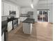 Bright kitchen with stainless steel appliances, white cabinetry and a center island at 4540 Flat Willow Pl, Douglasville, GA 30135