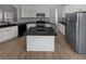Well-lit kitchen with white cabinetry, stainless steel appliances, dark countertops, and an island at 4540 Flat Willow Pl, Douglasville, GA 30135
