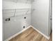 The laundry room features wire shelving, new floors, and utility connections at 4540 Flat Willow Pl, Douglasville, GA 30135