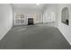 Spacious living room with fireplace, large windows and neutral carpet at 4540 Flat Willow Pl, Douglasville, GA 30135