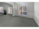 Well-lit living room with large windows, trim detail, and a view of the yard at 4540 Flat Willow Pl, Douglasville, GA 30135