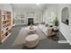Bright living room featuring a fireplace, plush seating, and large windows providing abundant natural light at 4540 Flat Willow Pl, Douglasville, GA 30135