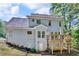 View of the backyard featuring a raised wooden deck and siding on a two-story home at 4668 Raiders Ridge Ct, Lithonia, GA 30038
