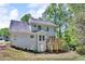 View of the backyard featuring a raised wooden deck and siding on a two-story home at 4668 Raiders Ridge Ct, Lithonia, GA 30038