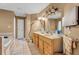 Bathroom featuring double sinks with a large mirror, a soaking tub, and tile flooring throughout at 4668 Raiders Ridge Ct, Lithonia, GA 30038