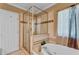 Bathroom featuring a soaking tub and a stand-up shower with a glass door, with tile flooring throughout at 4668 Raiders Ridge Ct, Lithonia, GA 30038
