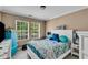 Bedroom with bed, two windows, gray-tone walls and trim, with light-colored wood floor at 4668 Raiders Ridge Ct, Lithonia, GA 30038