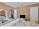 Bedroom with bed, television, gray-tone walls and trim, with light-colored wood floor at 4668 Raiders Ridge Ct, Lithonia, GA 30038